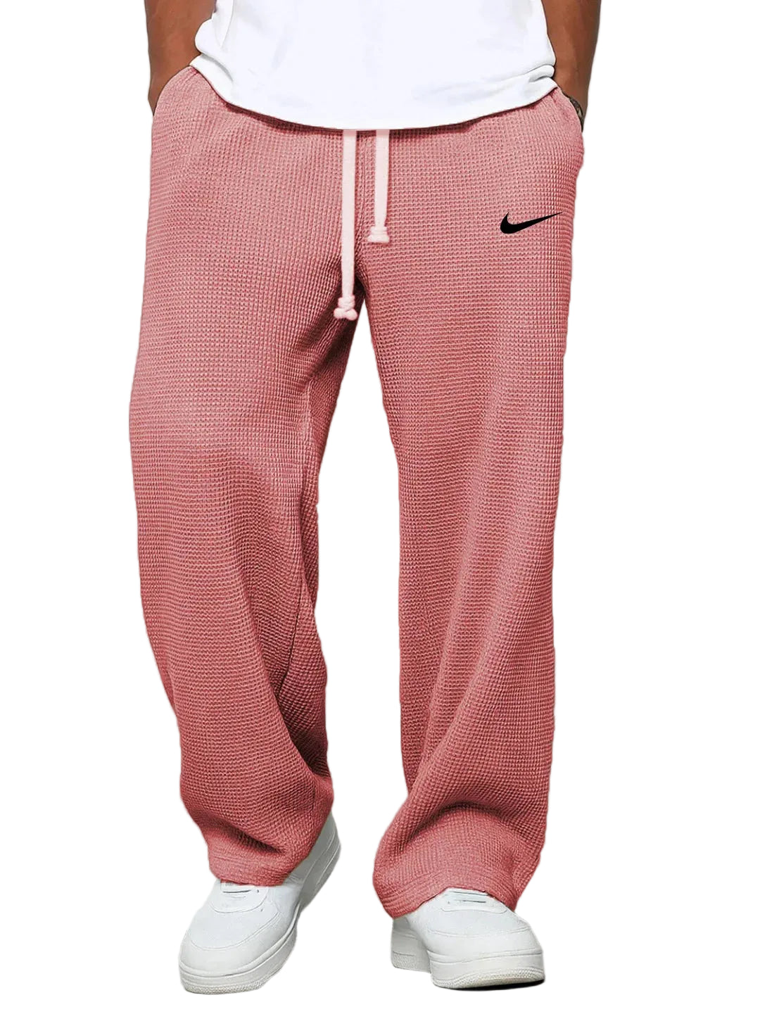 Person wearing red checkered Nike sweatpants on a white background